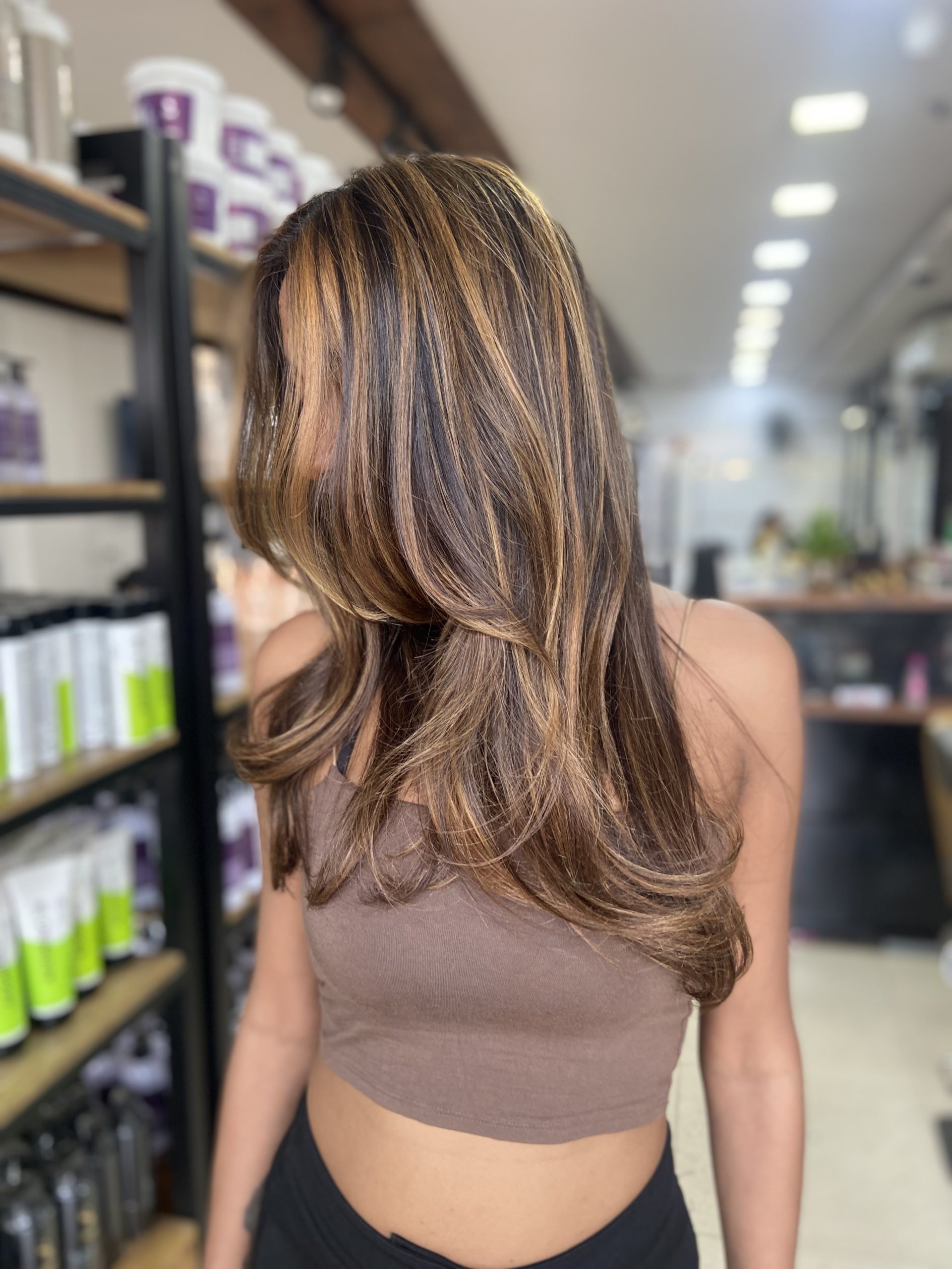Layered highlighted blowout at Tresses By Nitin